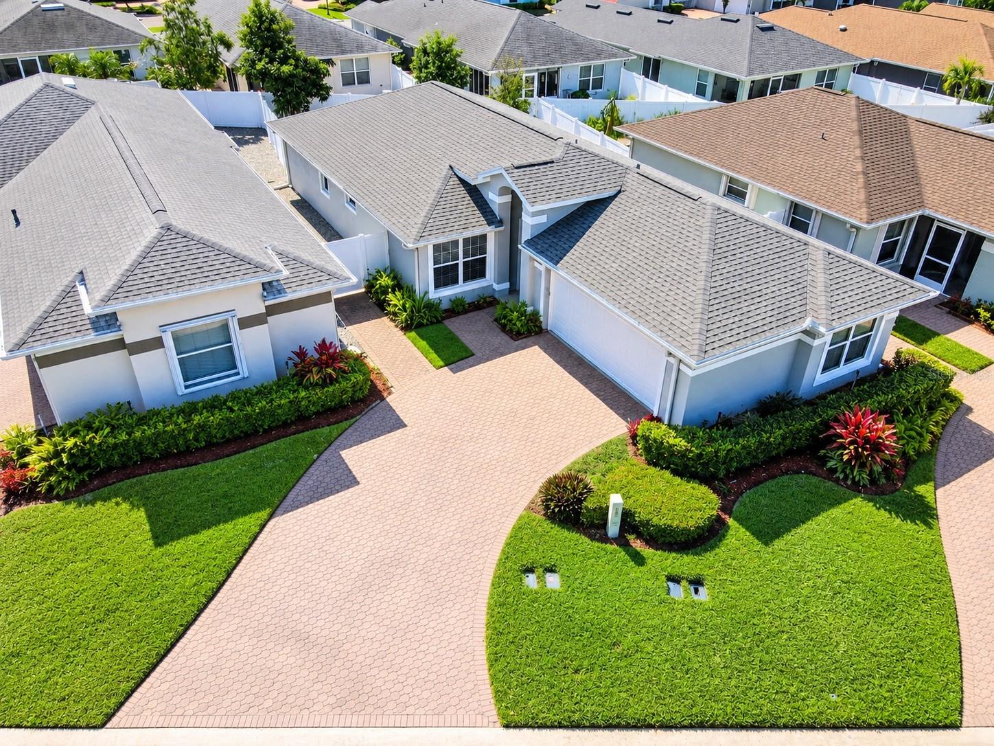 Architectural shingle roof (2020), HVAC system (2017), exterior lighting, water softener system, gutters, a glass entry storm door, and a two-car garage.