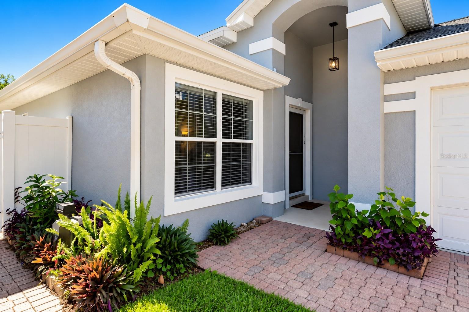 Charming covered entrance with glass storm door