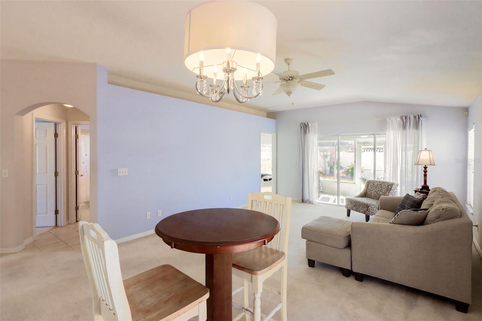 The dining area is highlighted by vaulted ceilings and glass sliding door that leads onto the fenced-in side yard