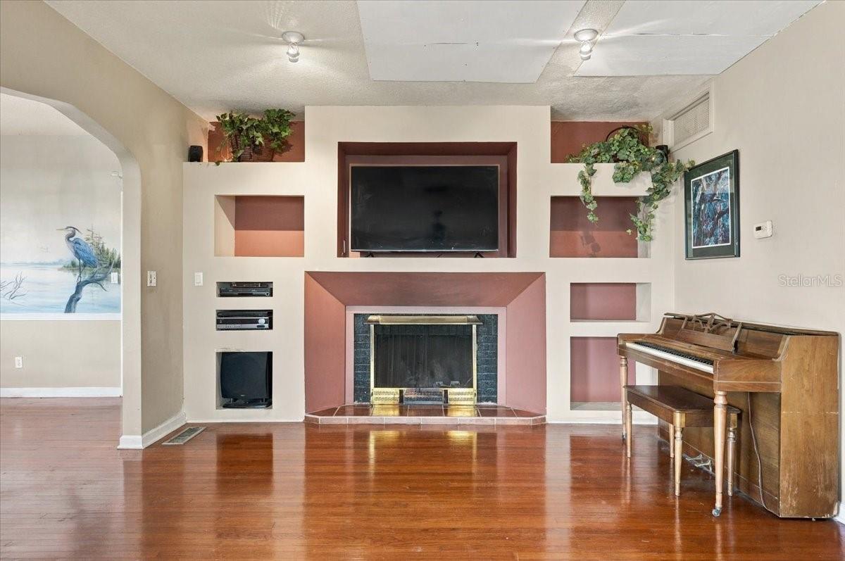 wood-burning fireplace w built-in shelving
