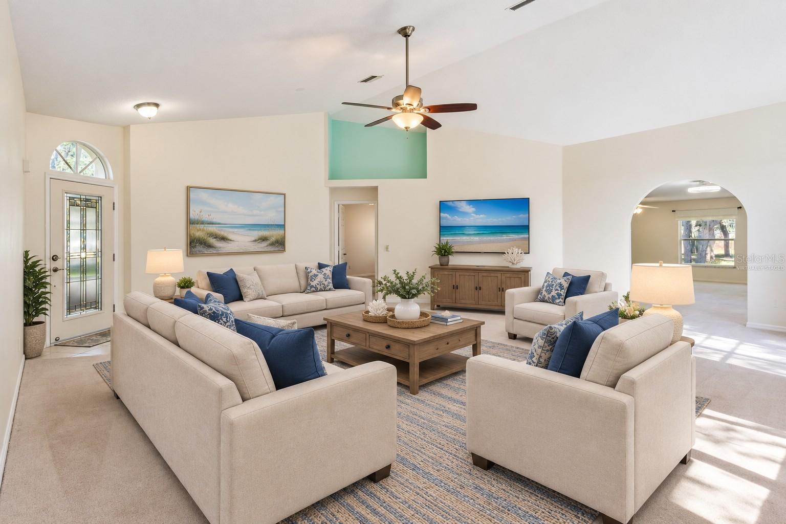Virtually Staged Living Room featuring Vaulted Ceilings and Decorative Planter Shelf