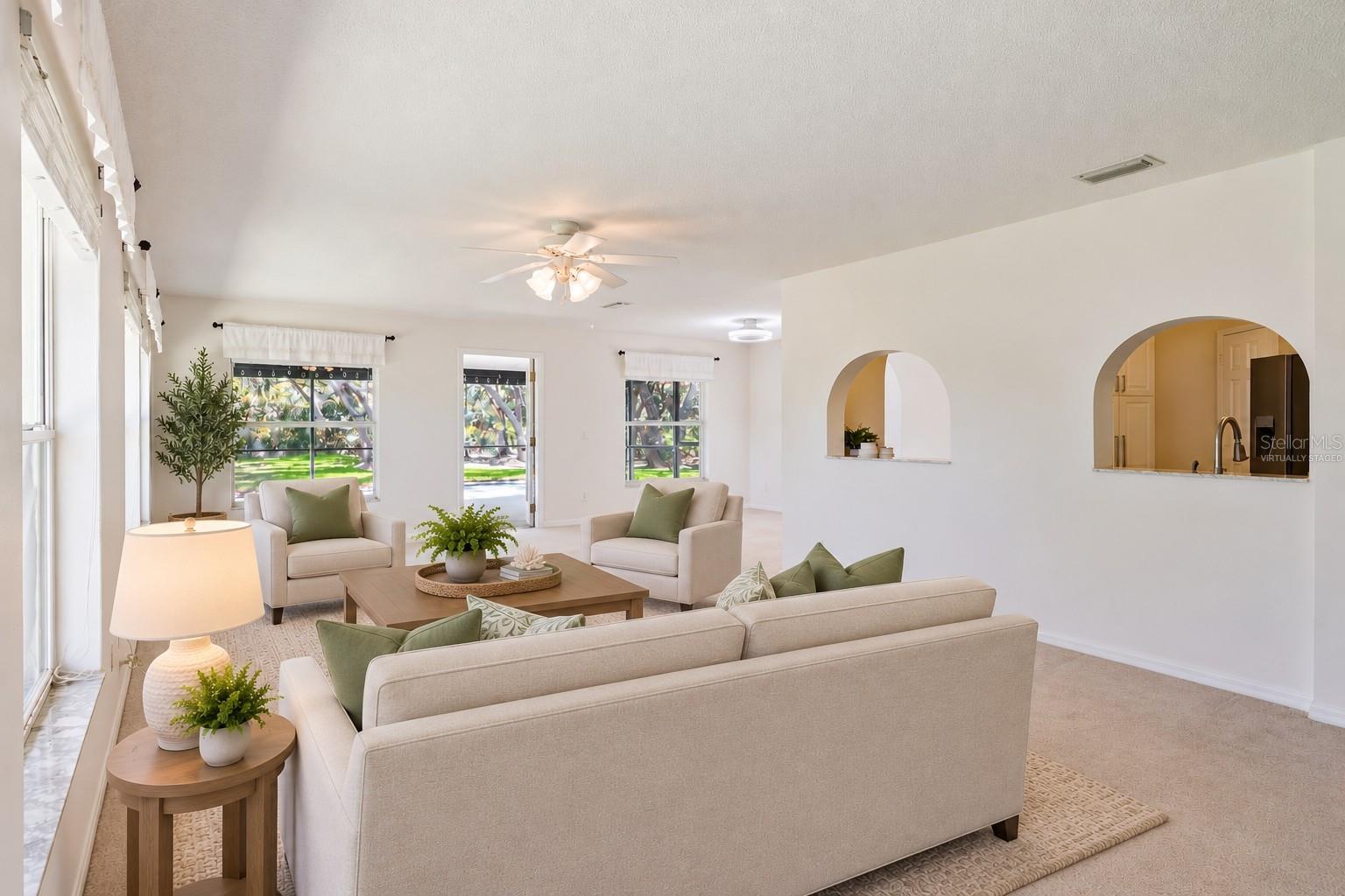 Virtually Staged Family Room offers access in to the Screened-in Lanai