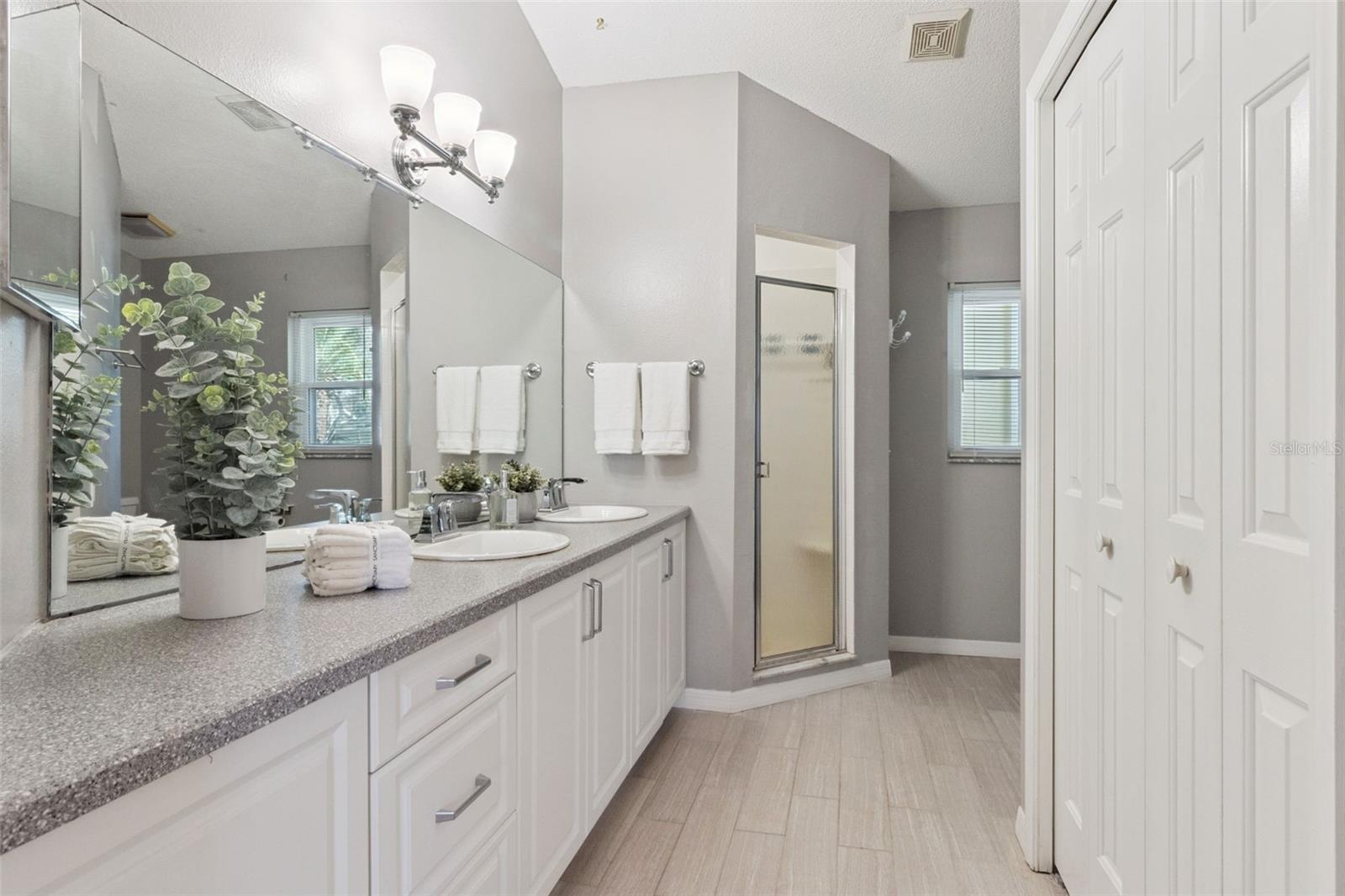 Primary Bathroom offers a Comfort Height Vanity with Dual Sinks and Walk-in Shower