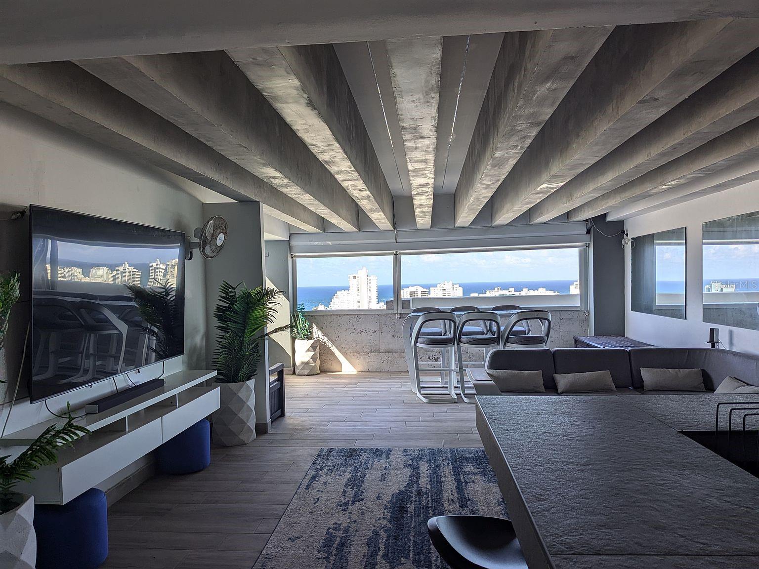 Covered terrace lounge  exposed beams and ocean views