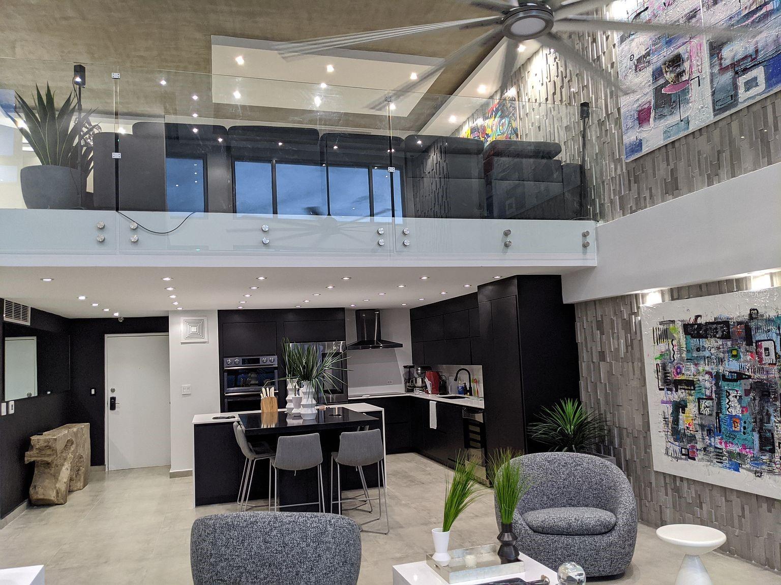 Kitchen and living  glass-rail loft above