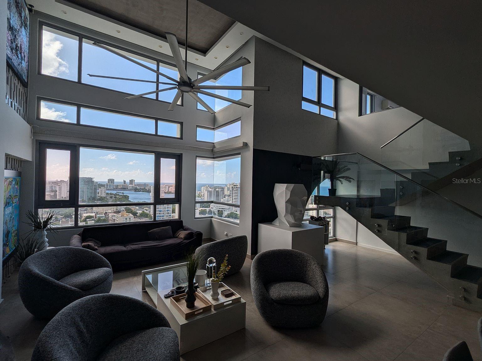 Living room double-height windows with lagoon and ocean views Living room double-height windows with lagoon and ocean views