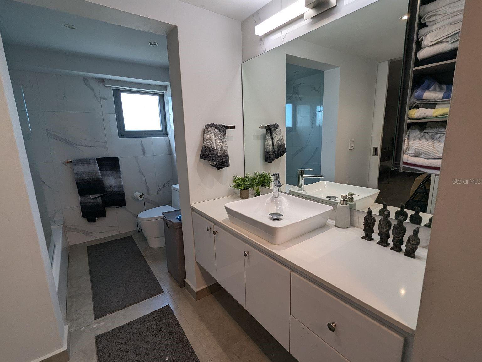 Bathroom marble-look tile and vessel-sink vanity Bathroom marble-look tile and vessel-sink vanity