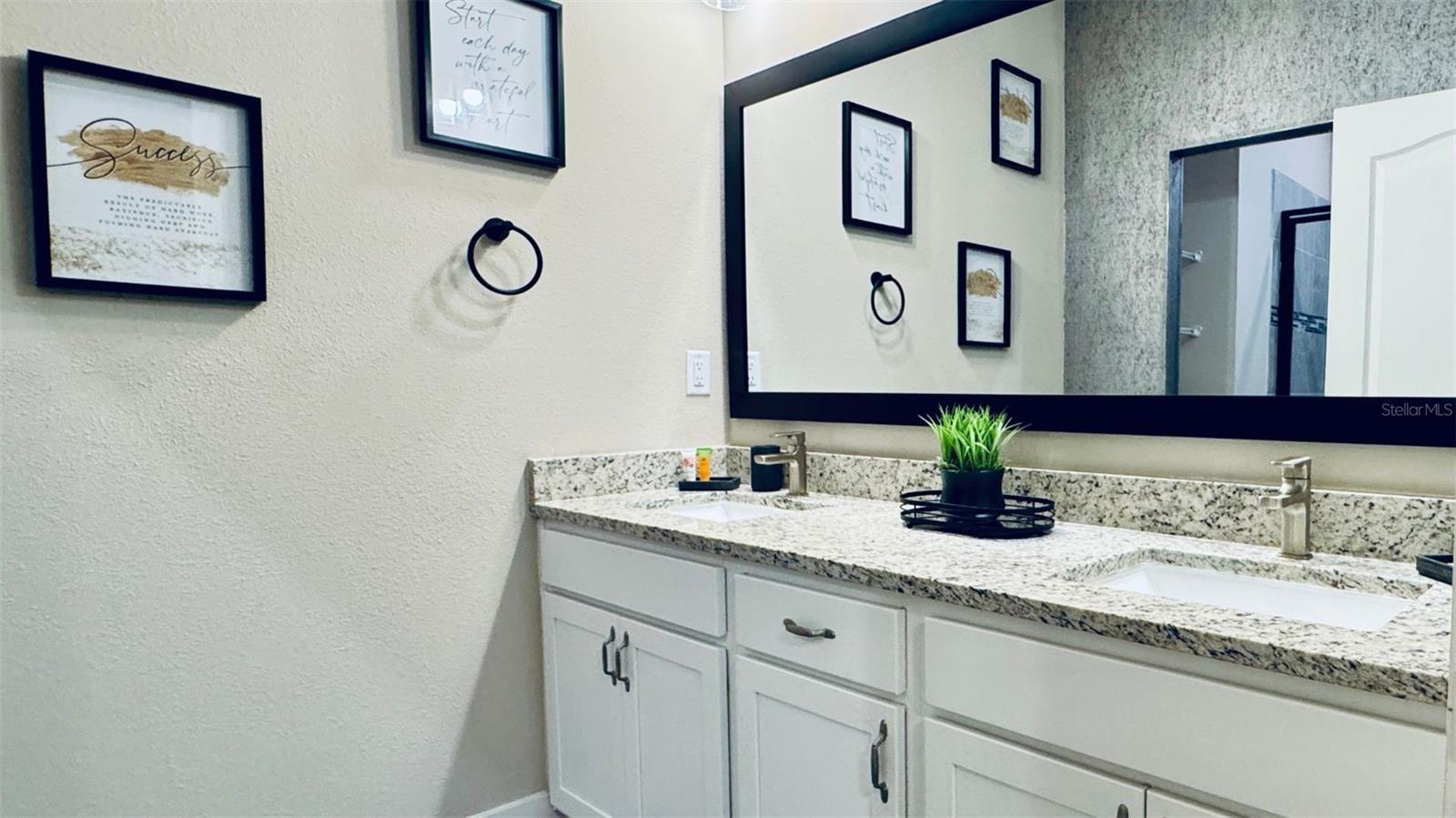 Well-appointed bathroom with modern finishes and ample storage.