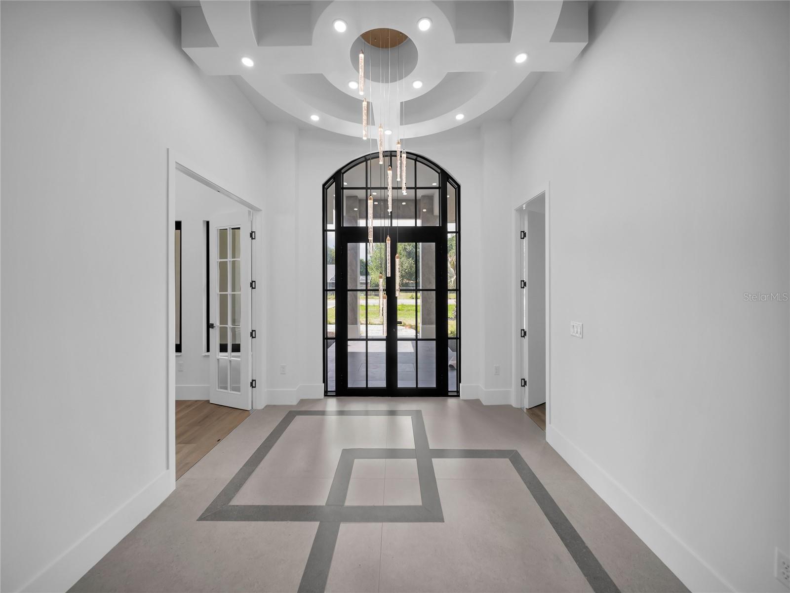 Dramatic foyer with custom ceiling detail