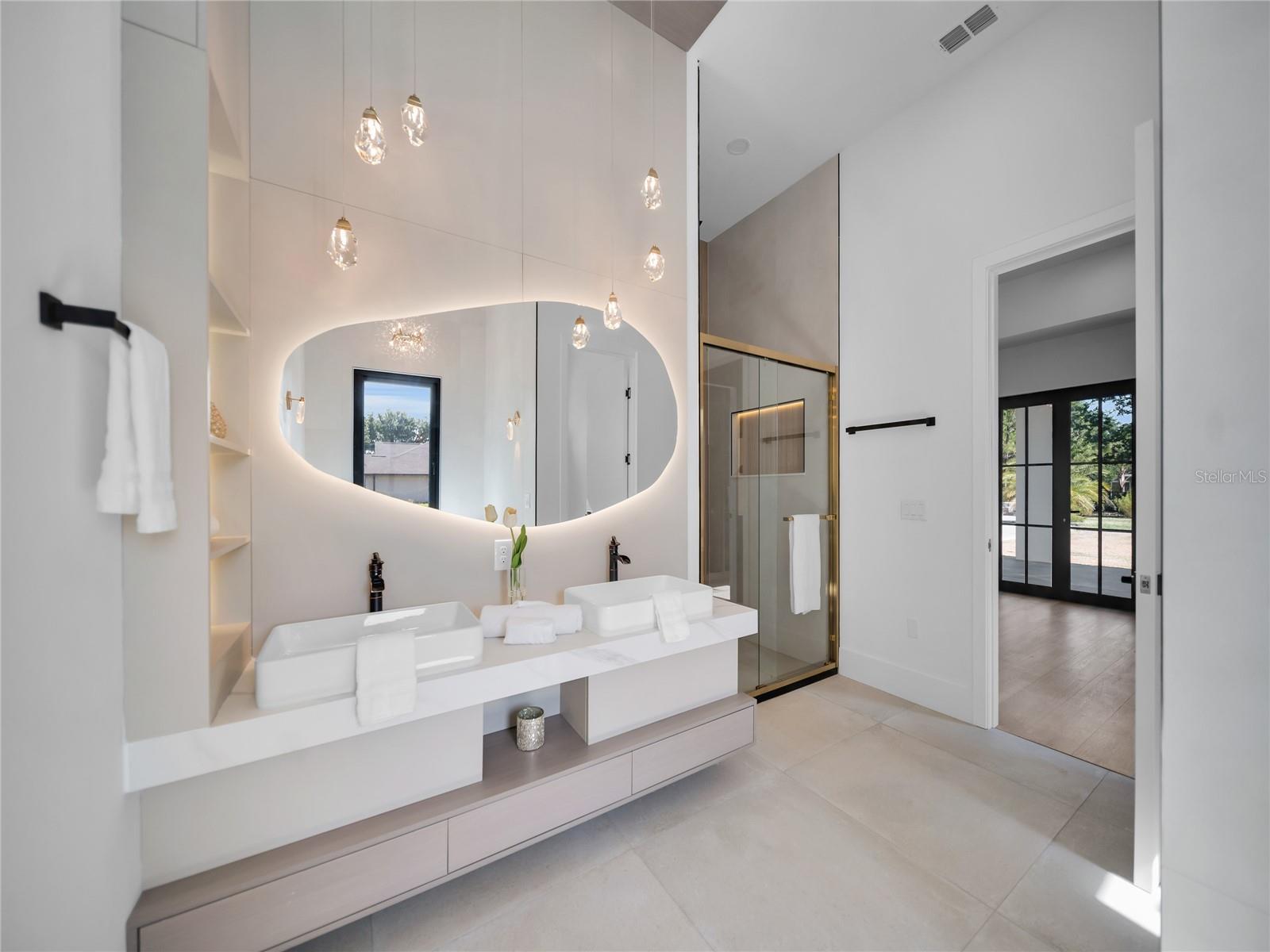 Primary bath with dual vanities and upscale finishes