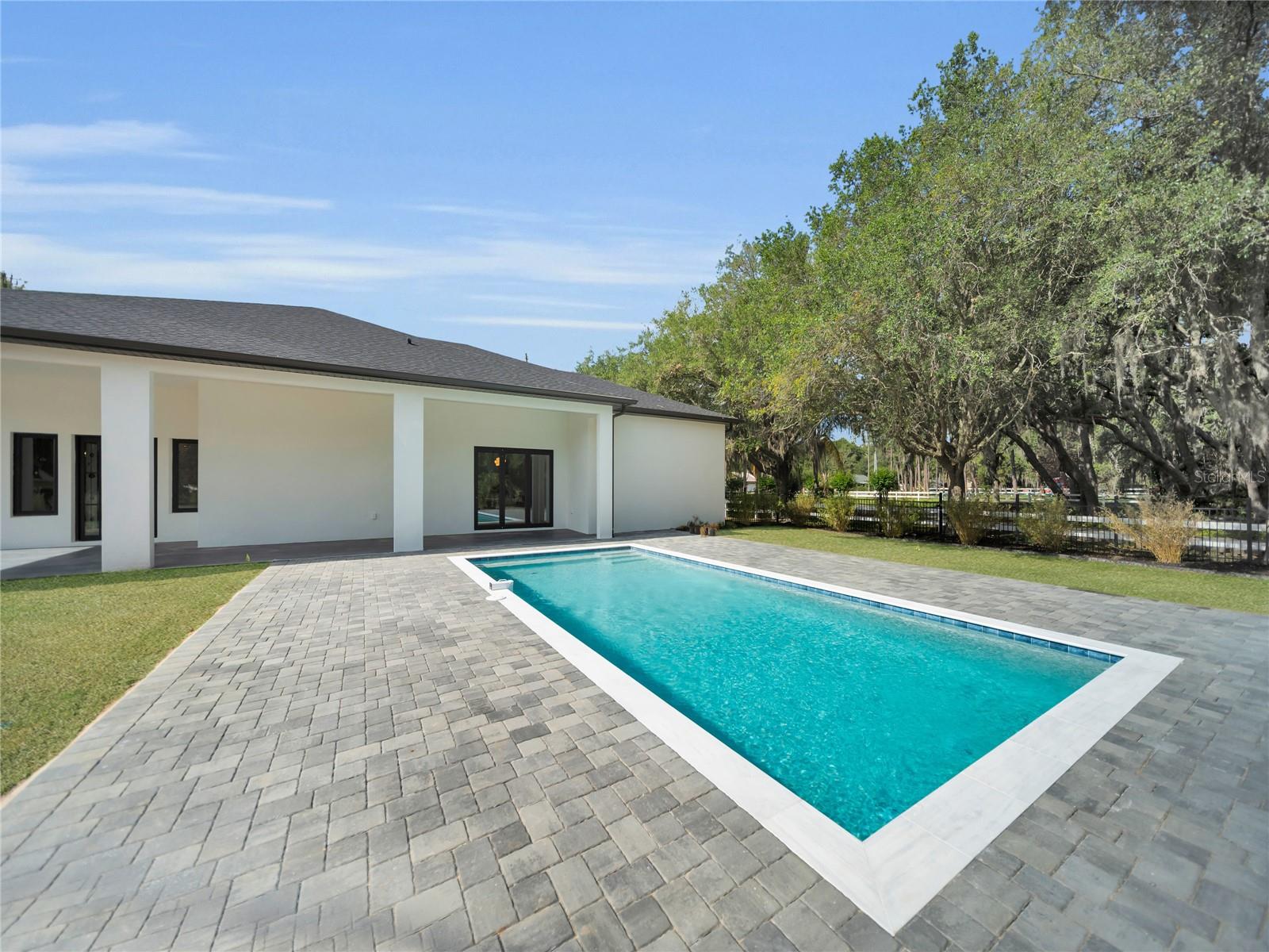 Pool with expansive paver deck