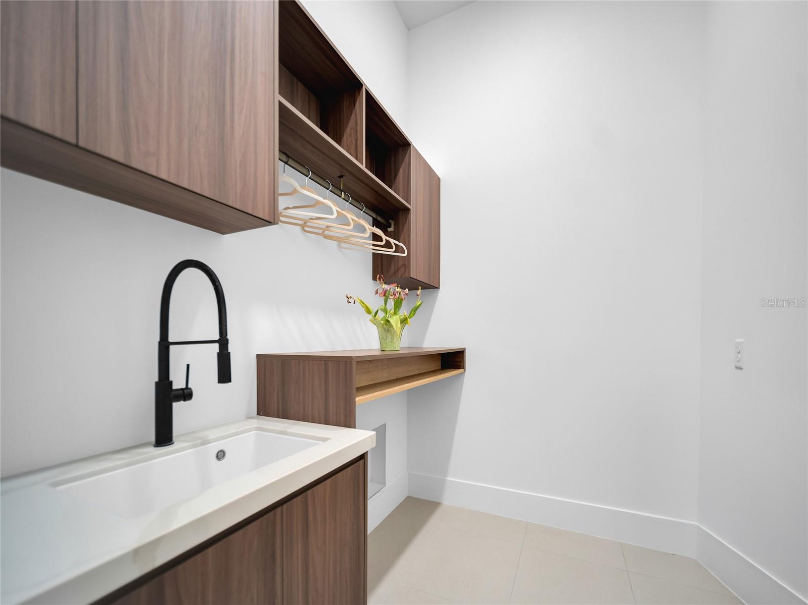Laundry room with cabinetry and utility sink