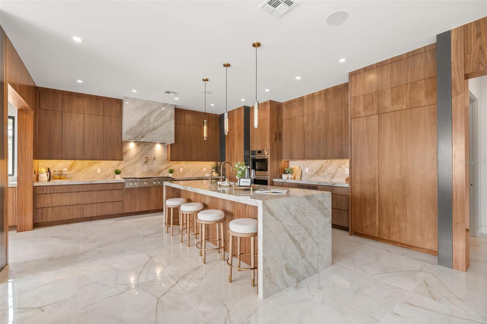 Kitchen has customised walnut cabinets and Taj Mahal counters