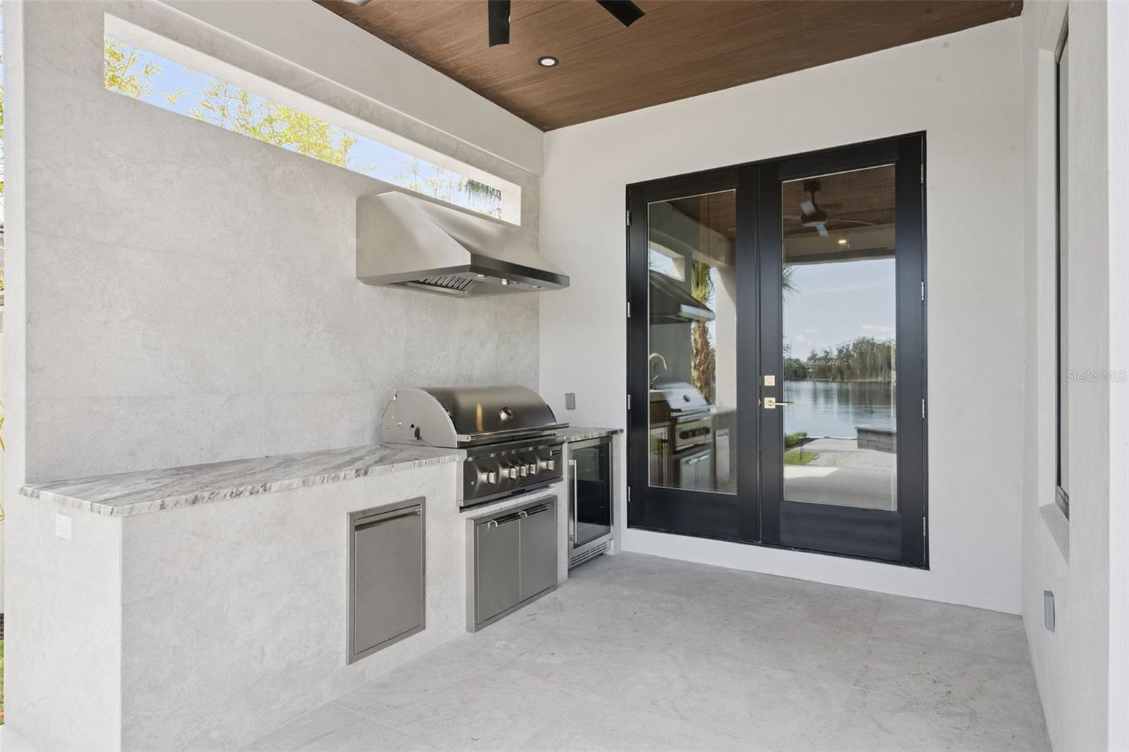 Outdoor Kitchen featuring grill and refrigerator