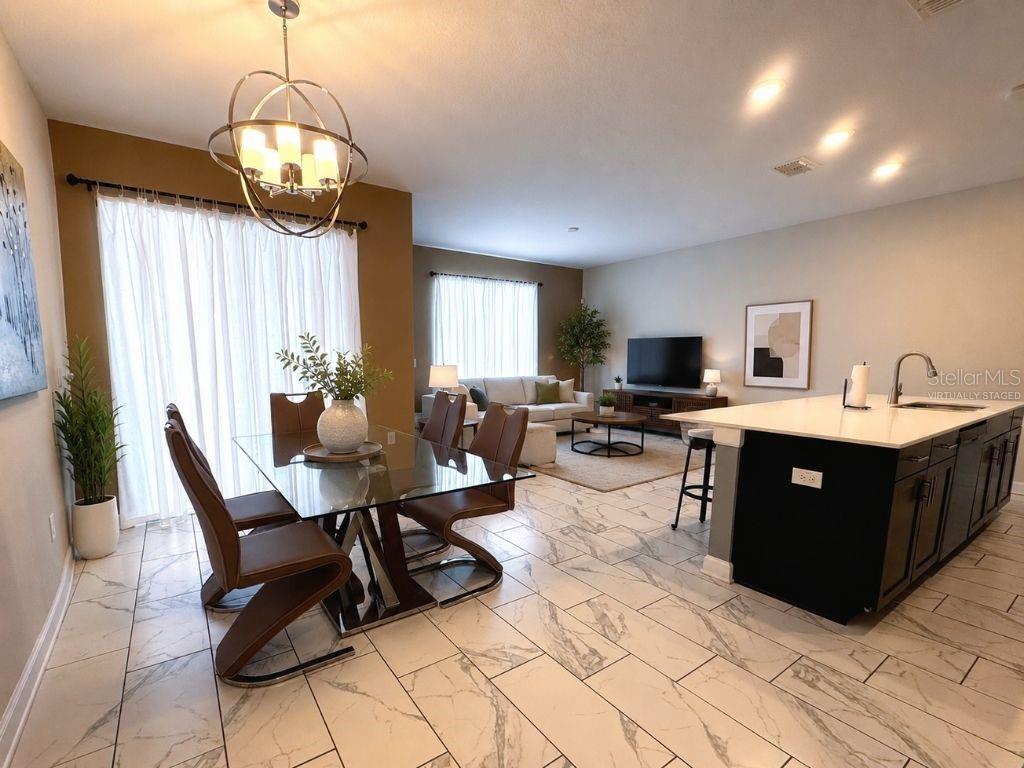 Virtually staged open-concept living, dining, and kitchen area showcasing the homes bright layout, stylish finishes, and comfortable gathering spaces. Virtually staged open-concept living, dining, and kitchen area showcasing the homes bright layout, stylish finishes, and comfortable gathering spaces.