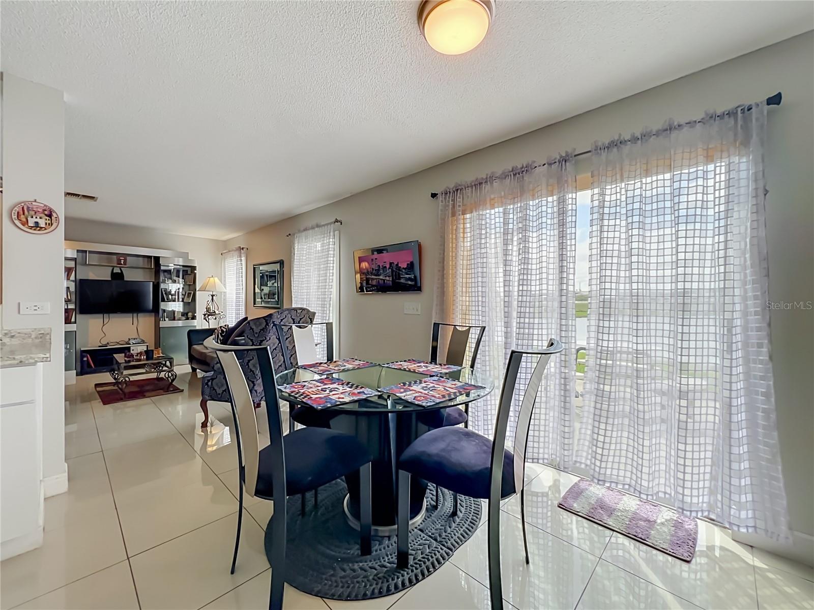 Dinette area with sliding doors to the back yard and pond front
