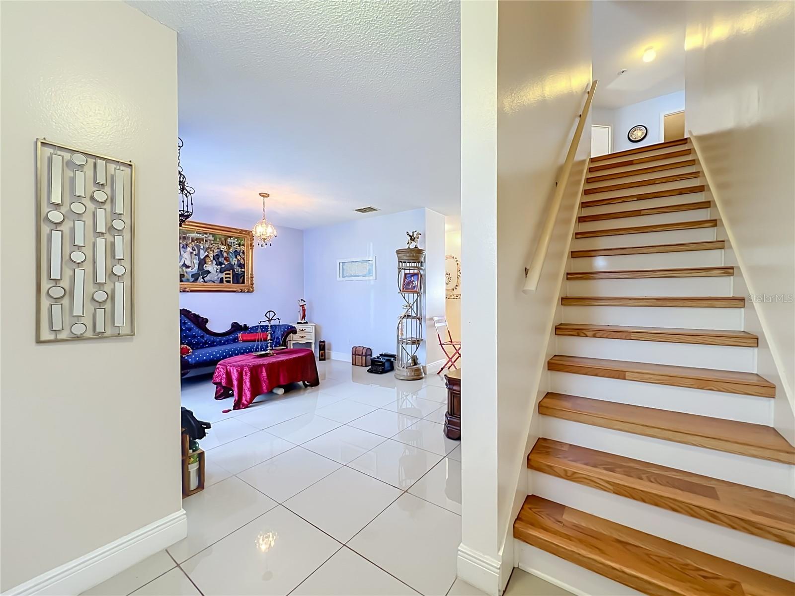 First floor is all ceramic tile, and wood leads to upstairs where all floors are wood laminate