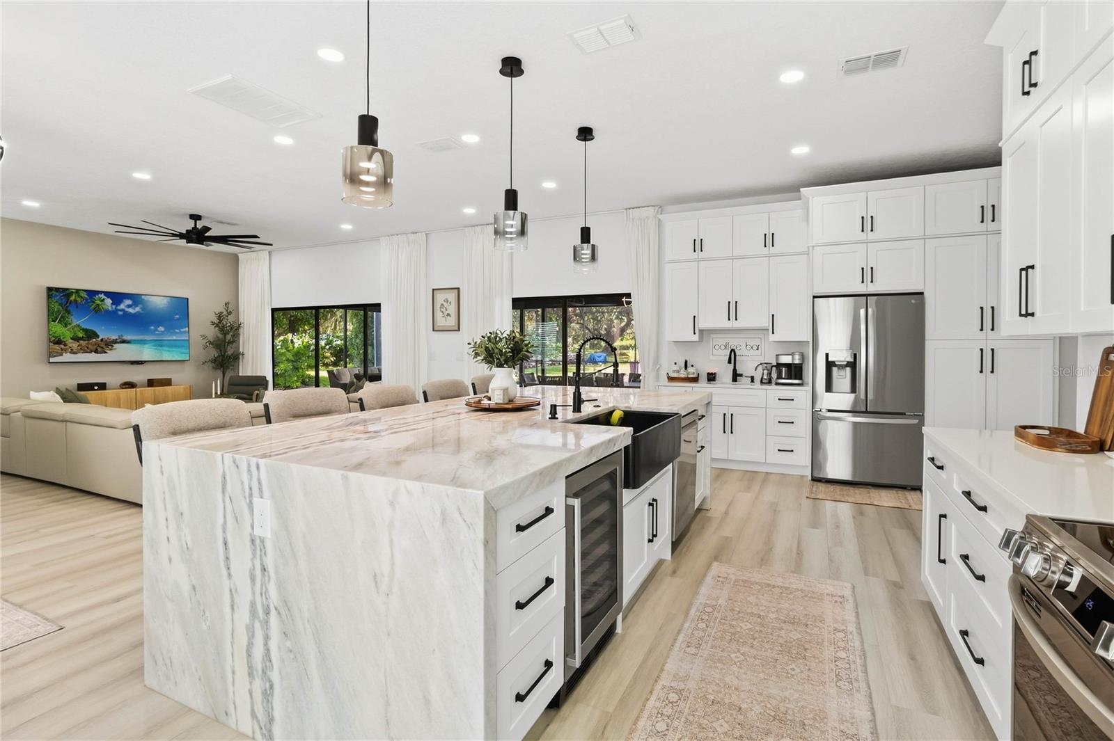 Kitchen Island with waterfall countertop, Wet Bar with 2nd sink to the left of the refigerator