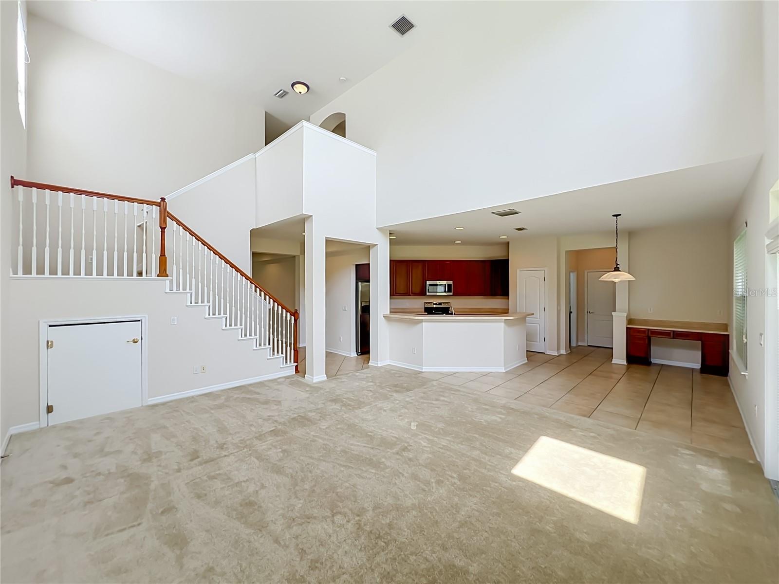 Family room/Kitchen/Dinette combination with 2-story ceiling