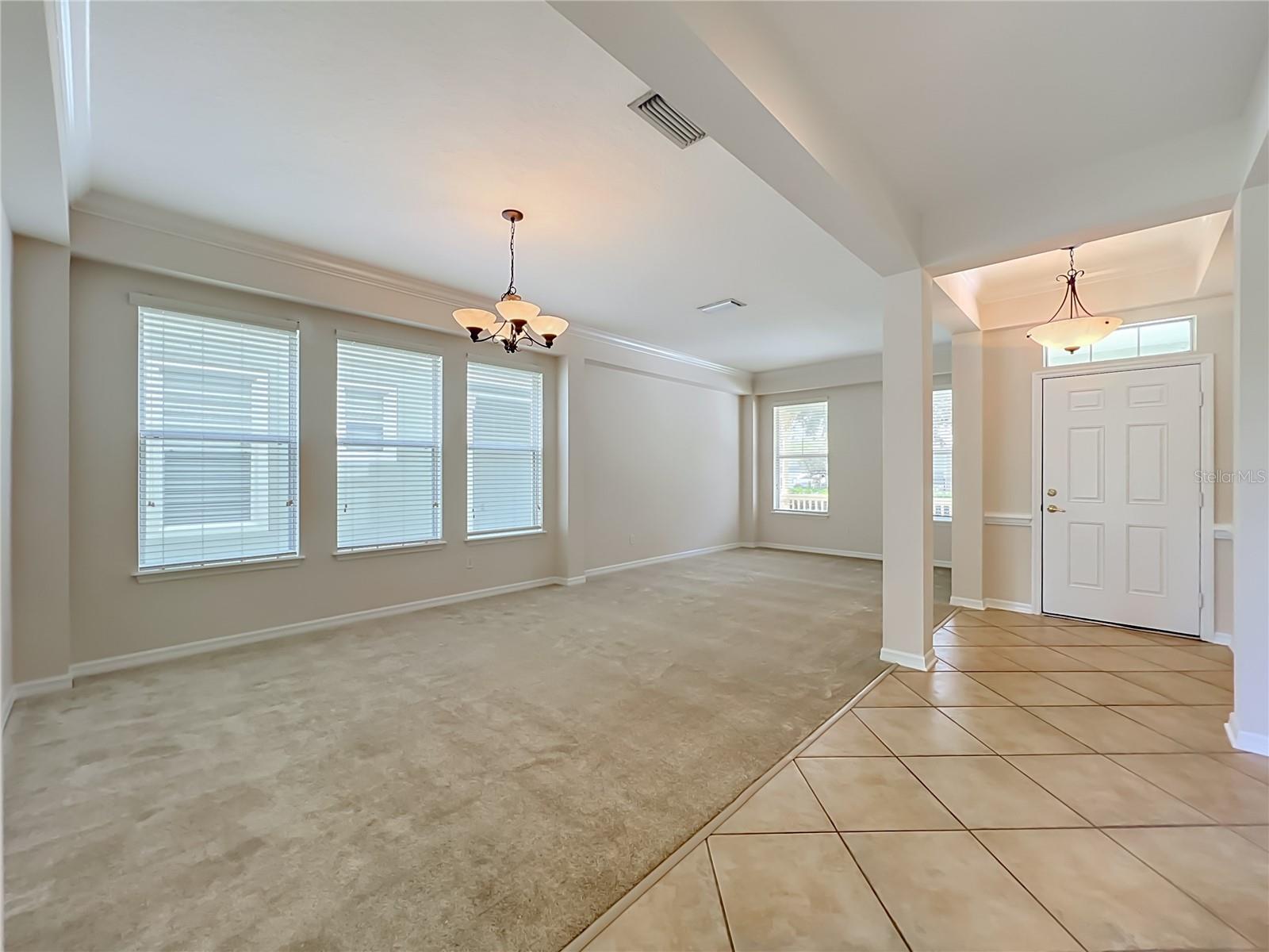Living room/Dining room combination with high ceilings, crown moldings, Ceramic tile at the front door entryway