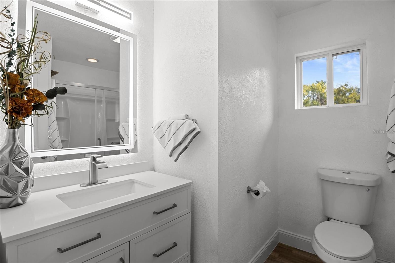 Primary Bathroom - Stone Countertops & Lighted Mirror