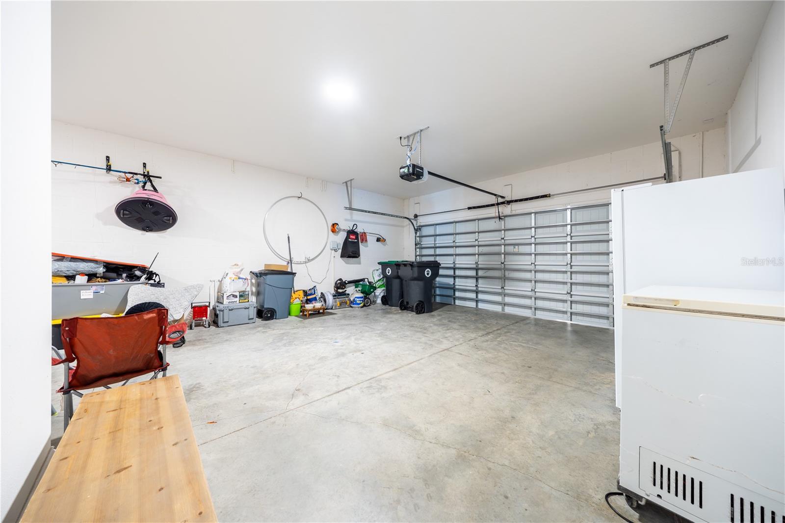Spacious two-car garage with an automatic door opener and room for additional storage.