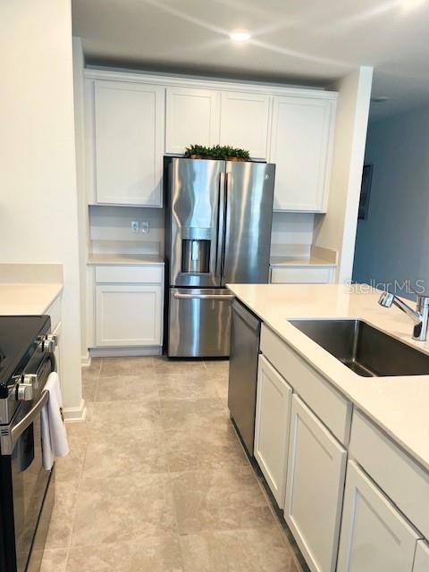 Kitchen w/Quartz Countertops & Stainless Steel Appliances & French Door Fridge