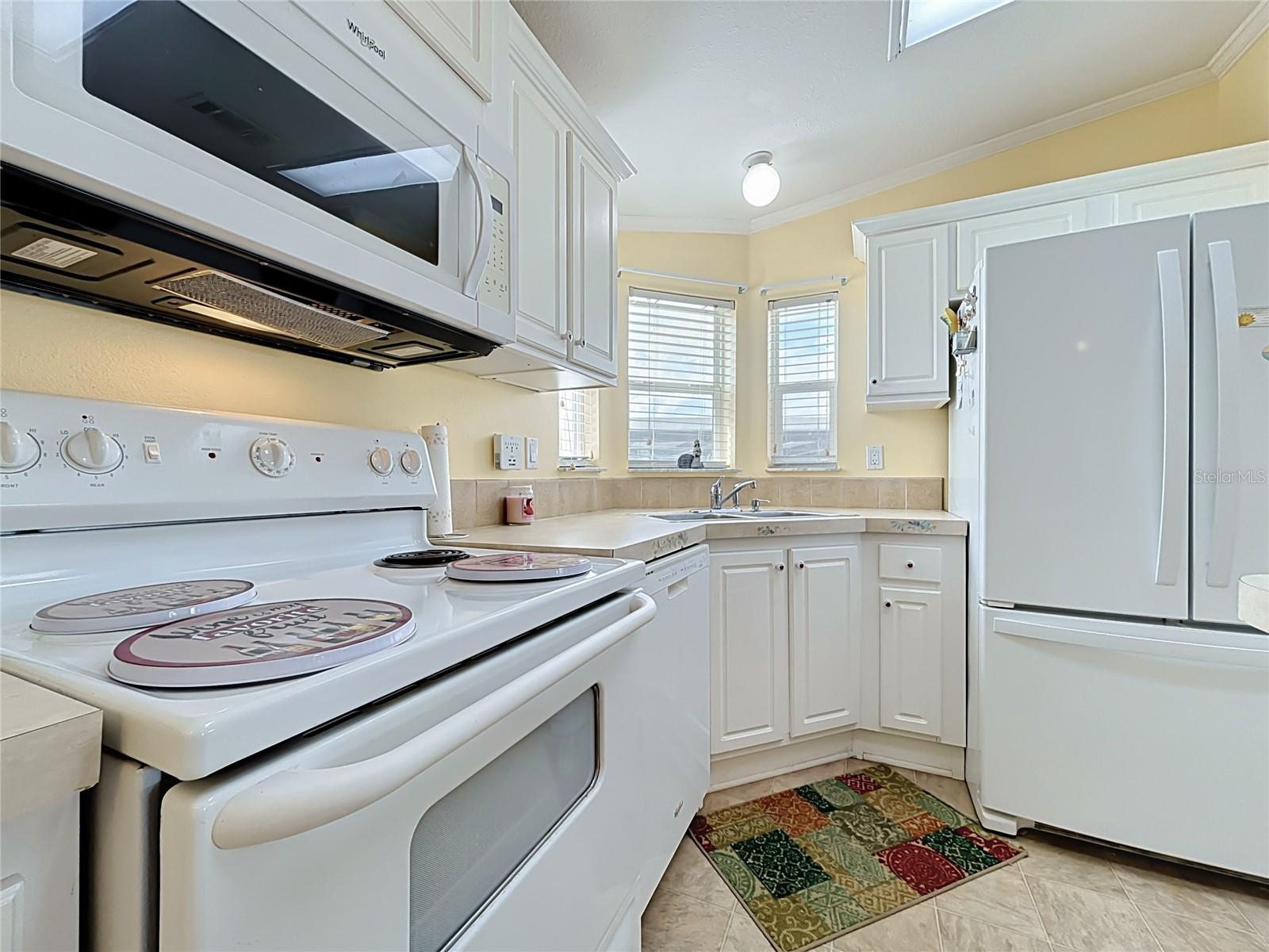Spacious kitchen with breakfast bar and pass through into living area
