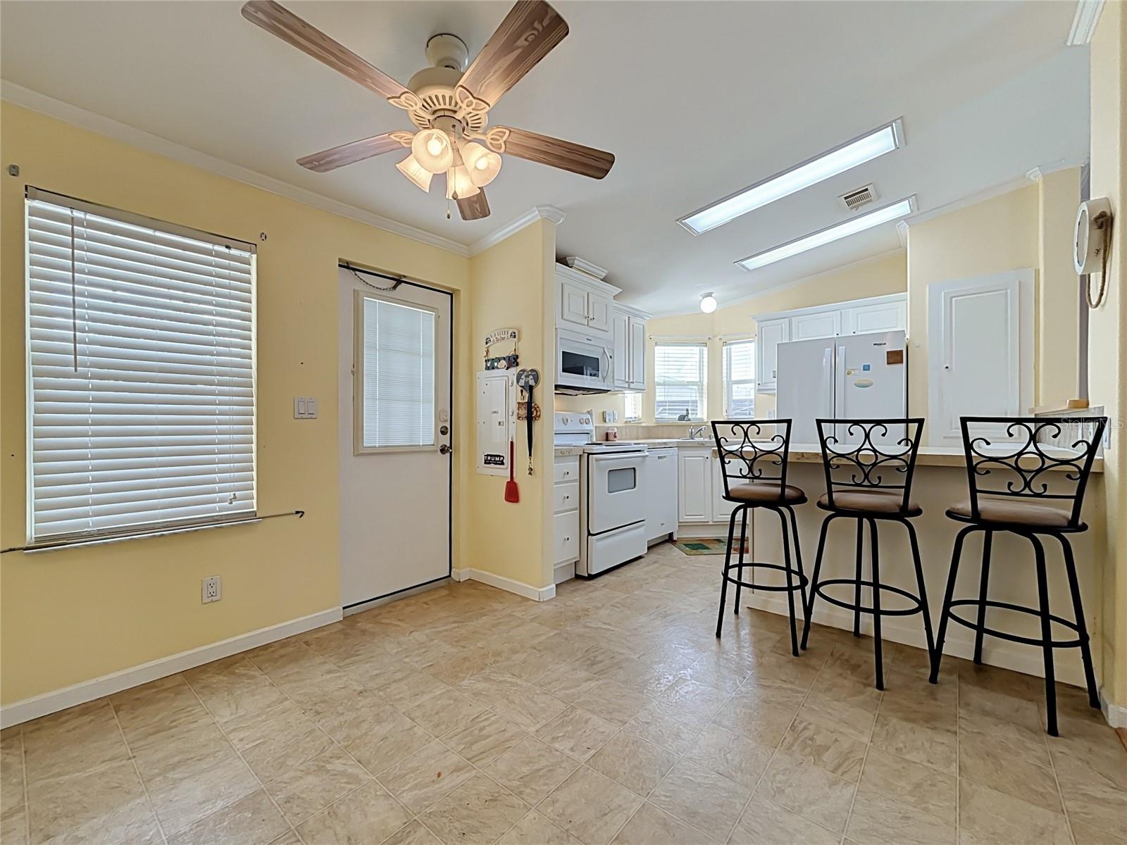 Dining room sits alongsiide kitchen overlooking front of the property.