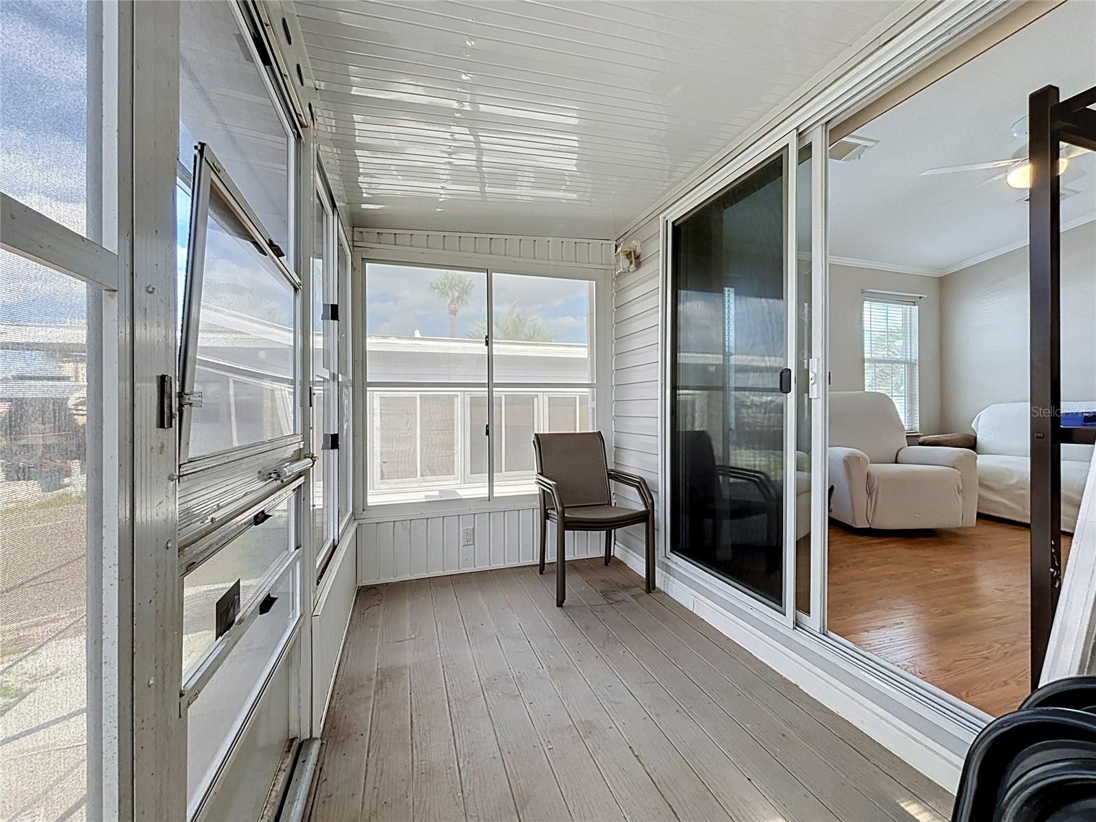 Screened in porch with vinyl windows provides wonderful views of the canal