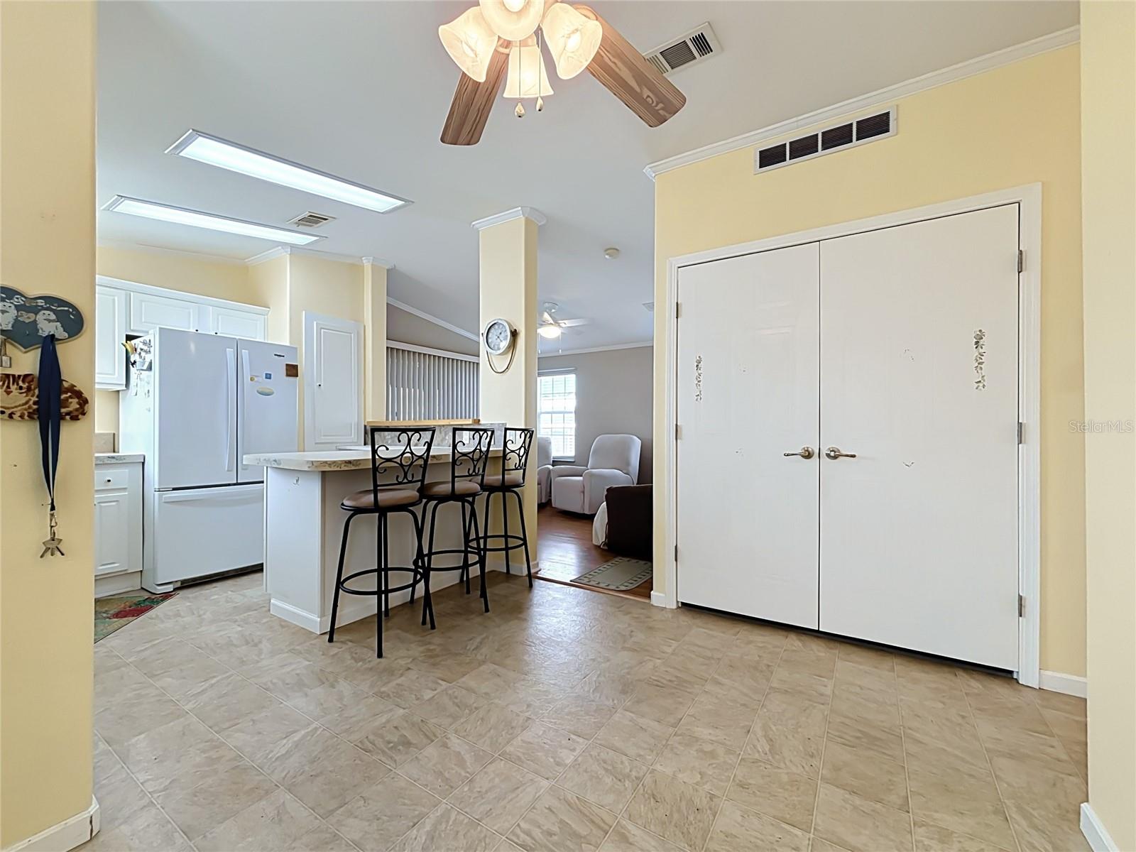 Behind those double doors is a stackable washer/dryer and storage space