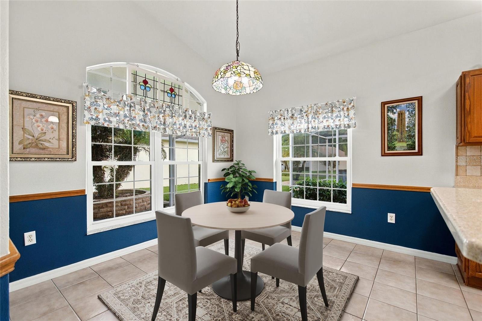 Virtually staged Kitchen eating area has vintage transom window