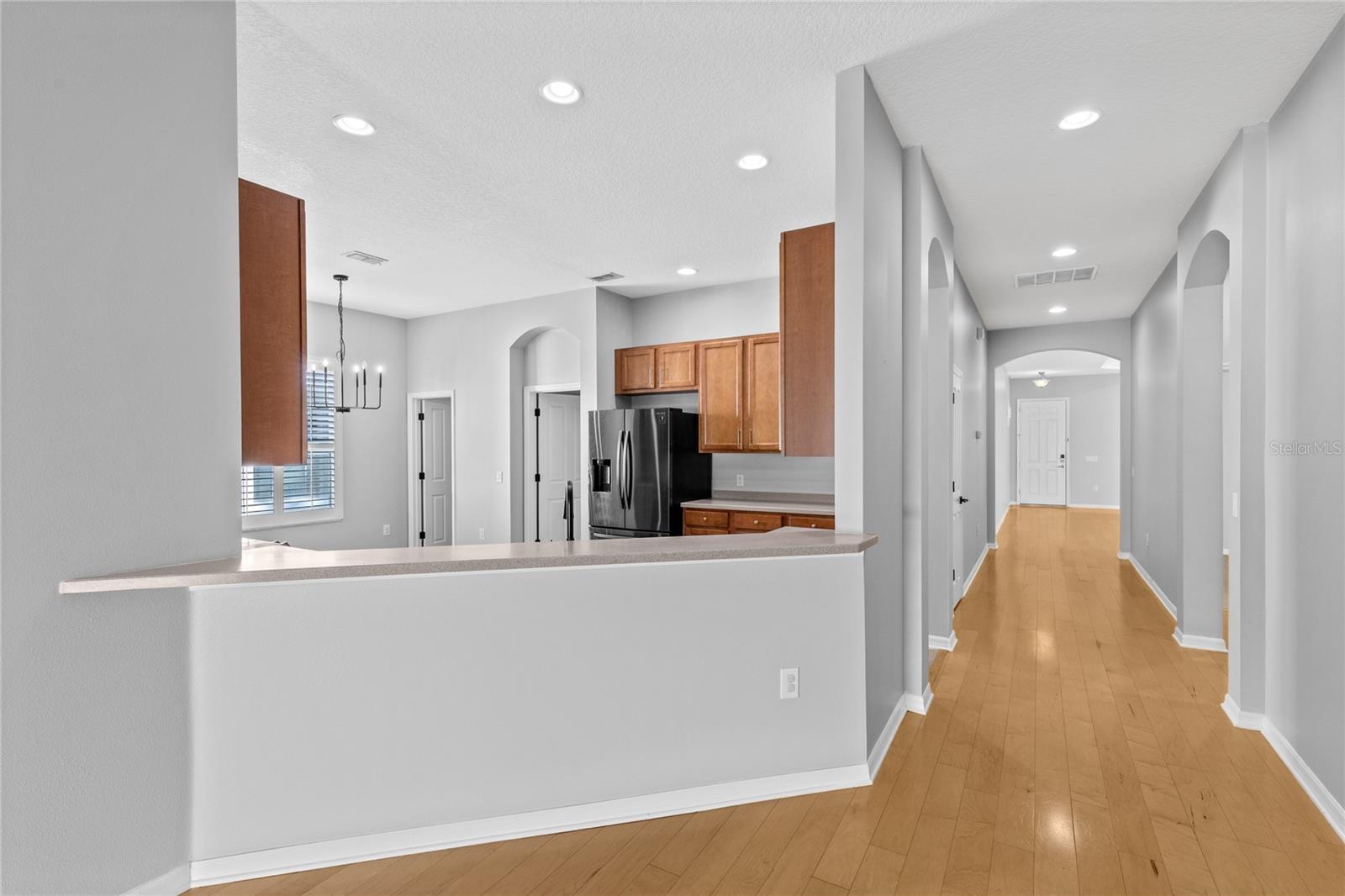 Hallway from front entry and flex room to kitchen