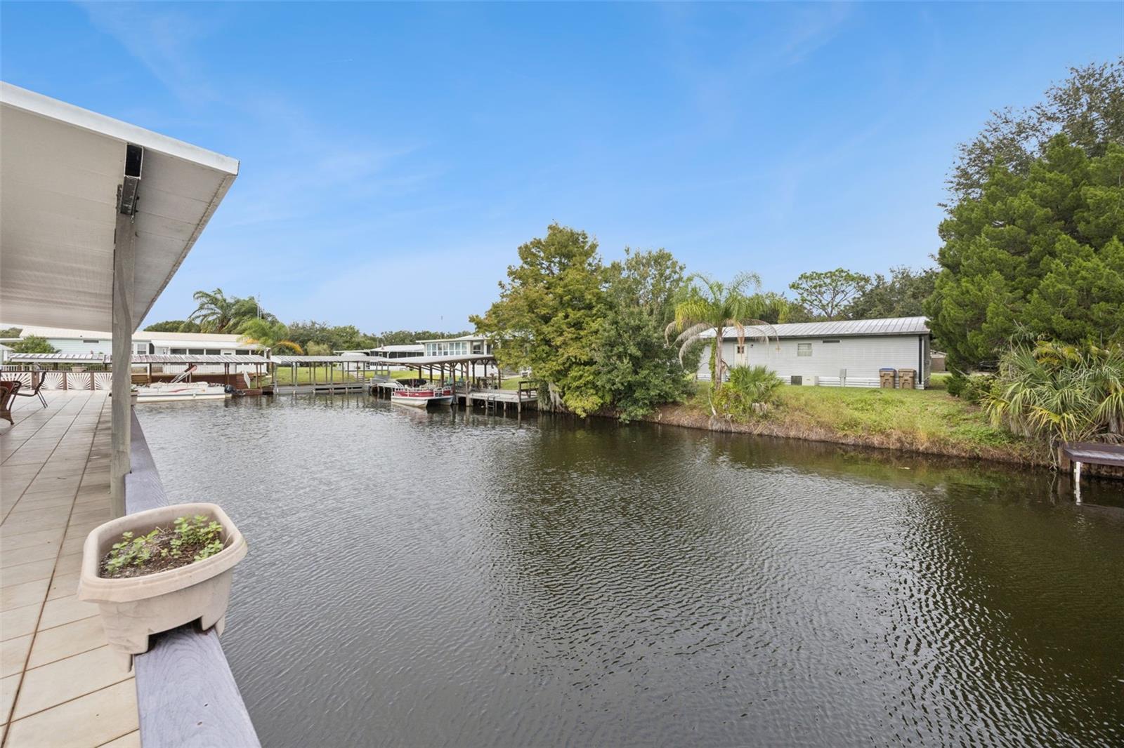 Canal View from Deck: Picturesque view along the navigable canal system from the private rear patio deck.