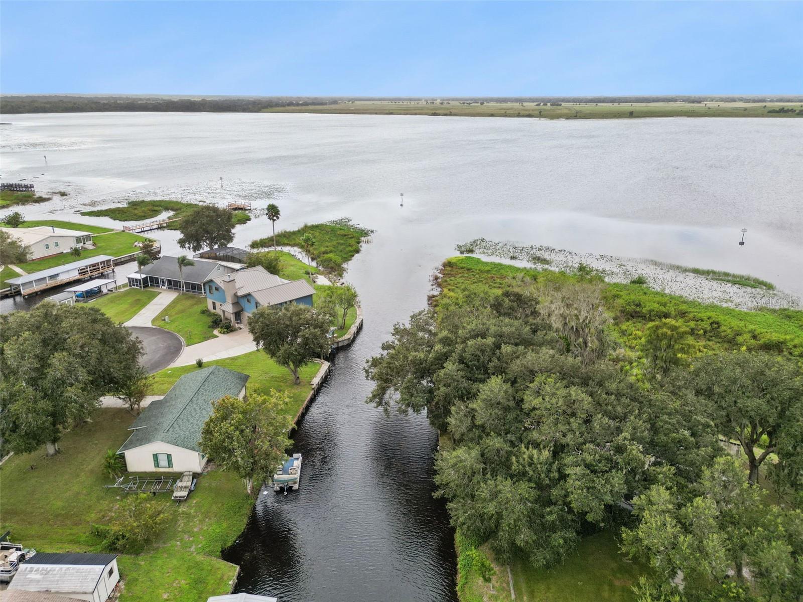 Aerial View of Canal Inlet: High-altitude photo capturing the mouth of the canal connecting directly into the open lake waters