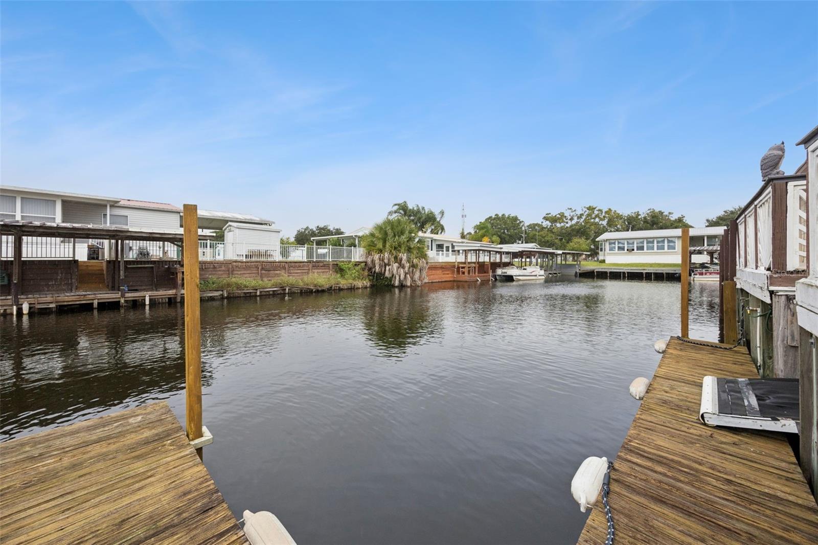 Canal Mooring Slip: Perspective of the private dock slip and canal frontage ideal for watercraft docking.