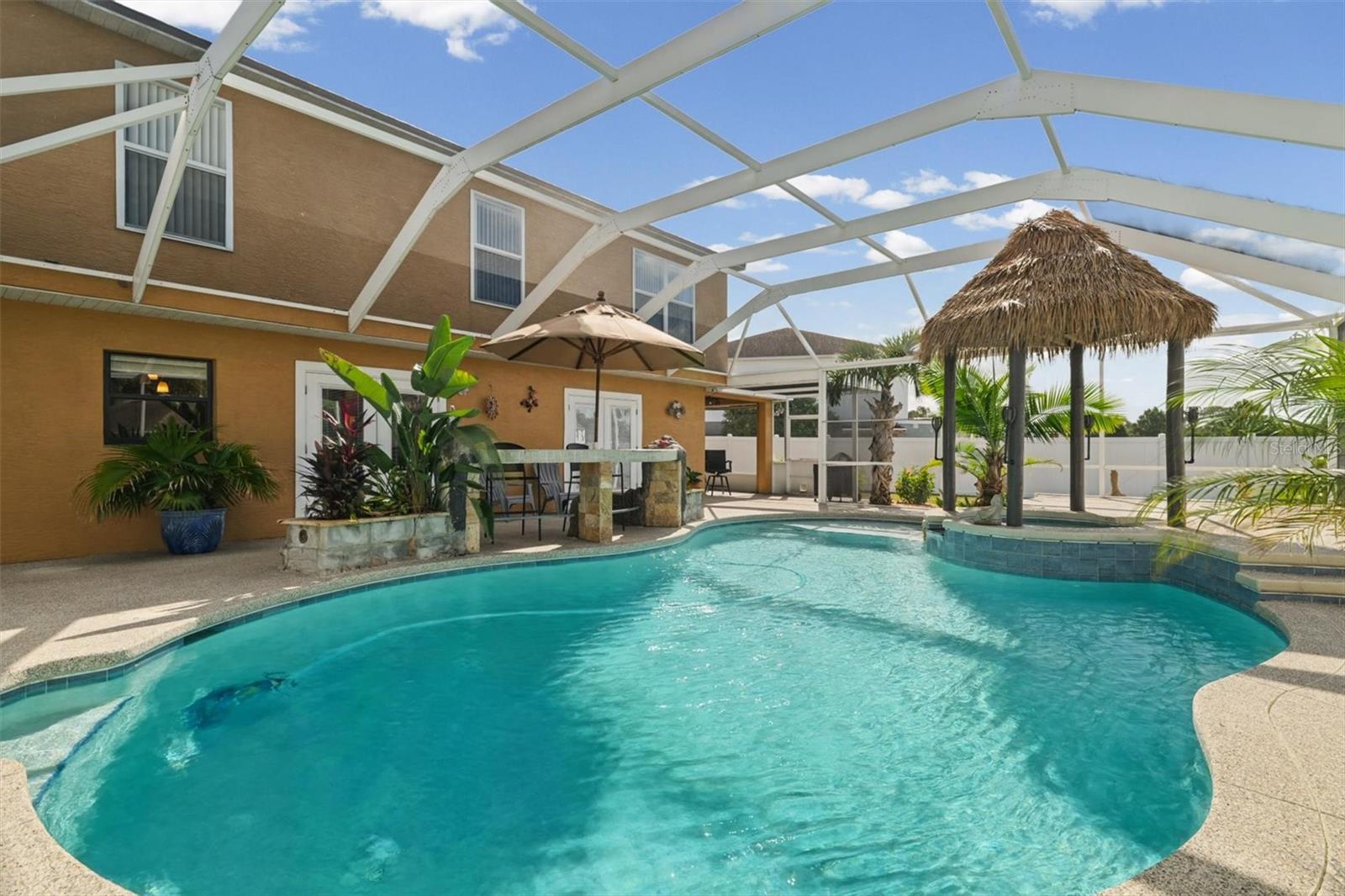 Screen Enclosed Pool/Spa with Outdoor Bar and Tiki-Style Gazebo