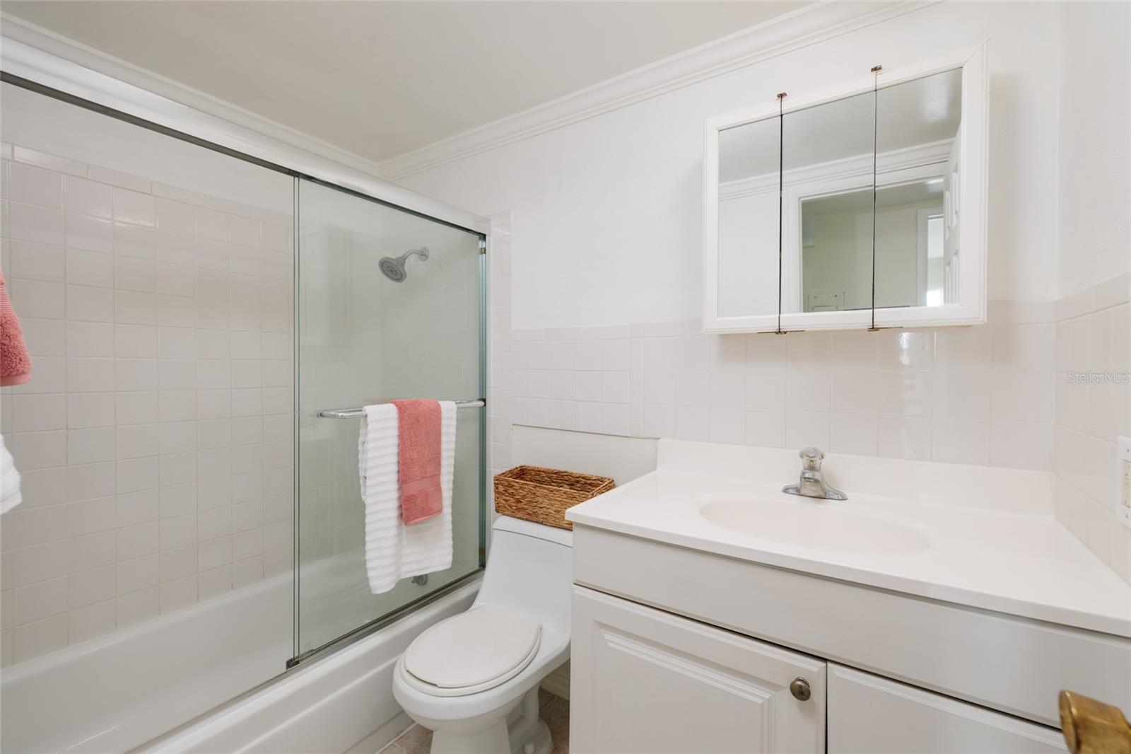 Bathroom w/GFCI outlet, exhaust fan & Crown molding.