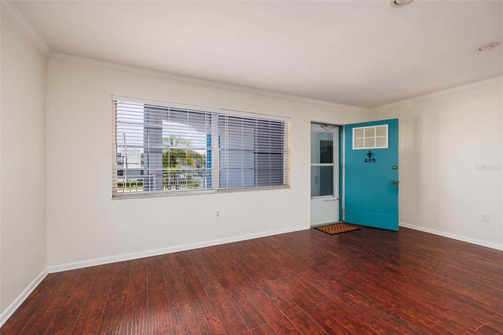 Large living room windows with tropical views. Screened storm door. Large living room windows with tropical views. Screened storm door.