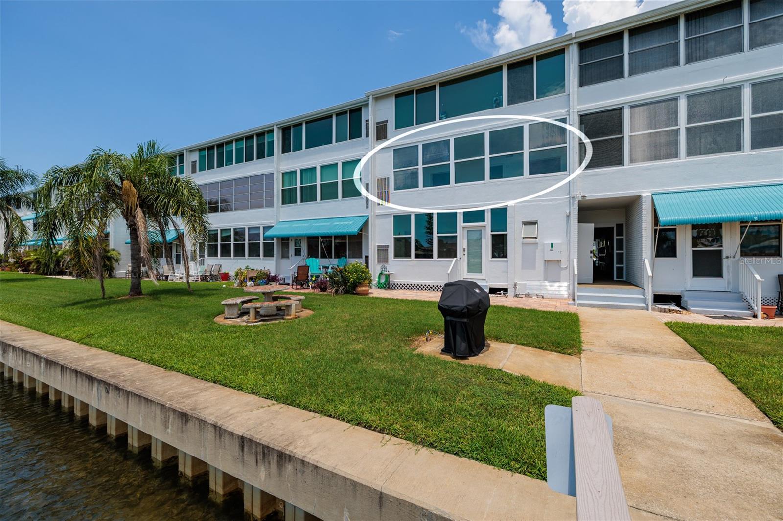 #209. Newer seawall. Bathroom just inside the bldg doorway. Grilling/picnic area.