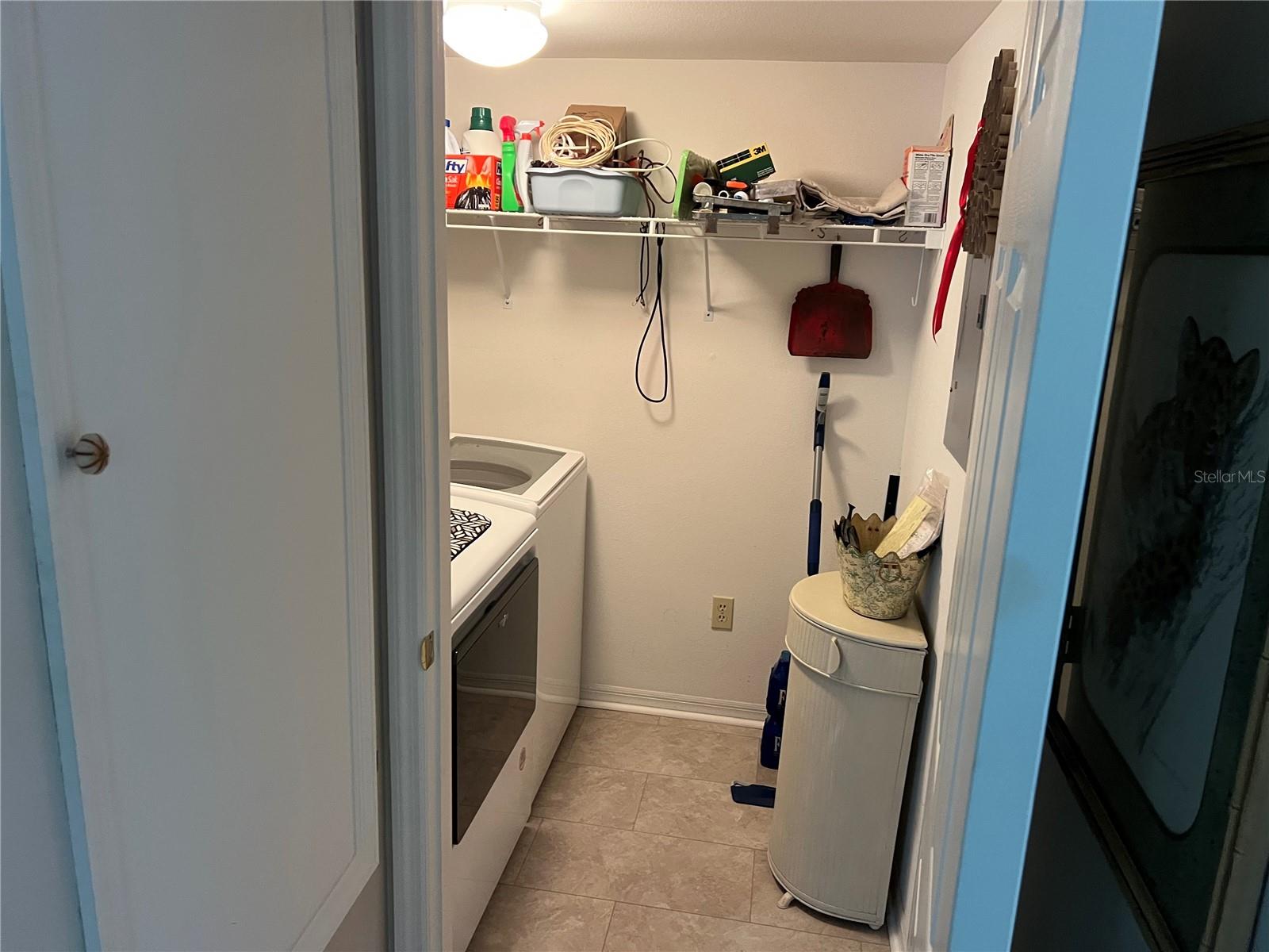 Laundry room with storage shelf