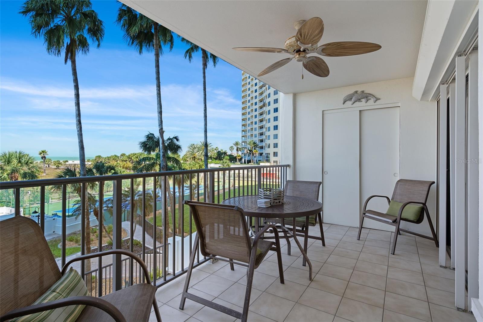 Spacious covered patio for enjoying the fresh air, salty breezes and beautiful views.  Storage closet for beach chairs and pool floatys!