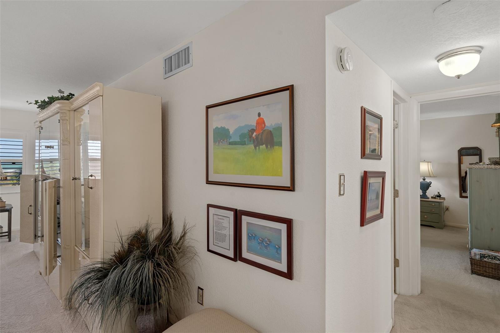 Hallway to bedrooms & bathrooms is adjacent to dining area
