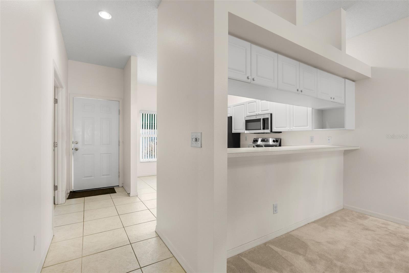 Defined foyer with tile flooring and a convenient pass-through to the kitchen, creating an open connection to the main living and dining areas. Defined foyer with tile flooring and a convenient pass-through to the kitchen, creating an open connection to the main living and dining areas.