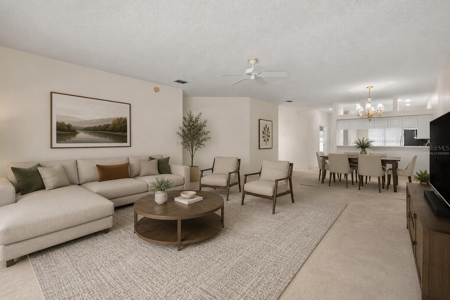 Spacious living and dining areas with an open connection to the kitchen, creating an easy flow for both daily living and entertaining. This photo has been virtually staged. Spacious living and dining areas with an open connection to the kitchen, creating an easy flow for both daily living and entertaining. This photo has been virtually staged.