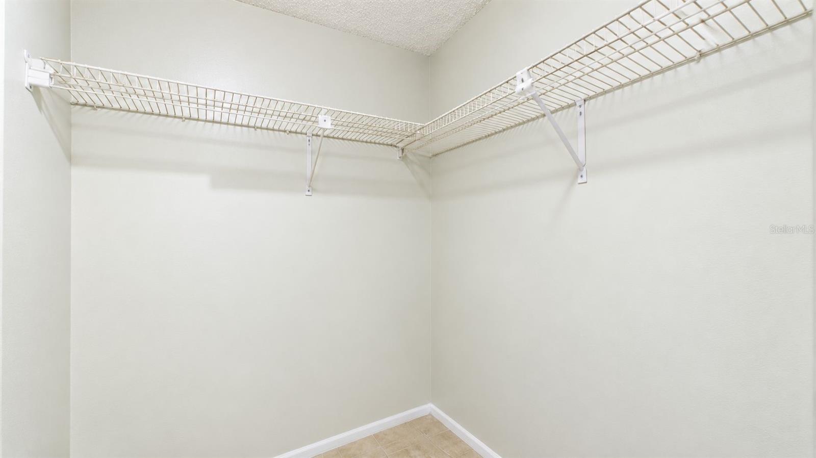 Primary bedroom walk-in closet