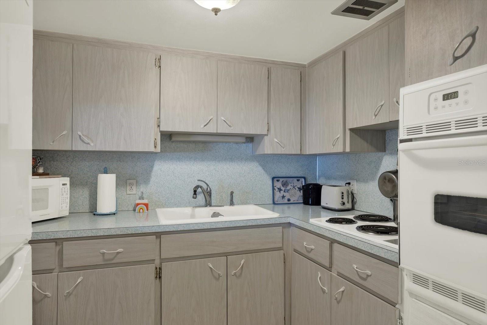 Kitchen-Ample-Cabinetry-Double-Sink-White-Appliances-Clearwater-FL