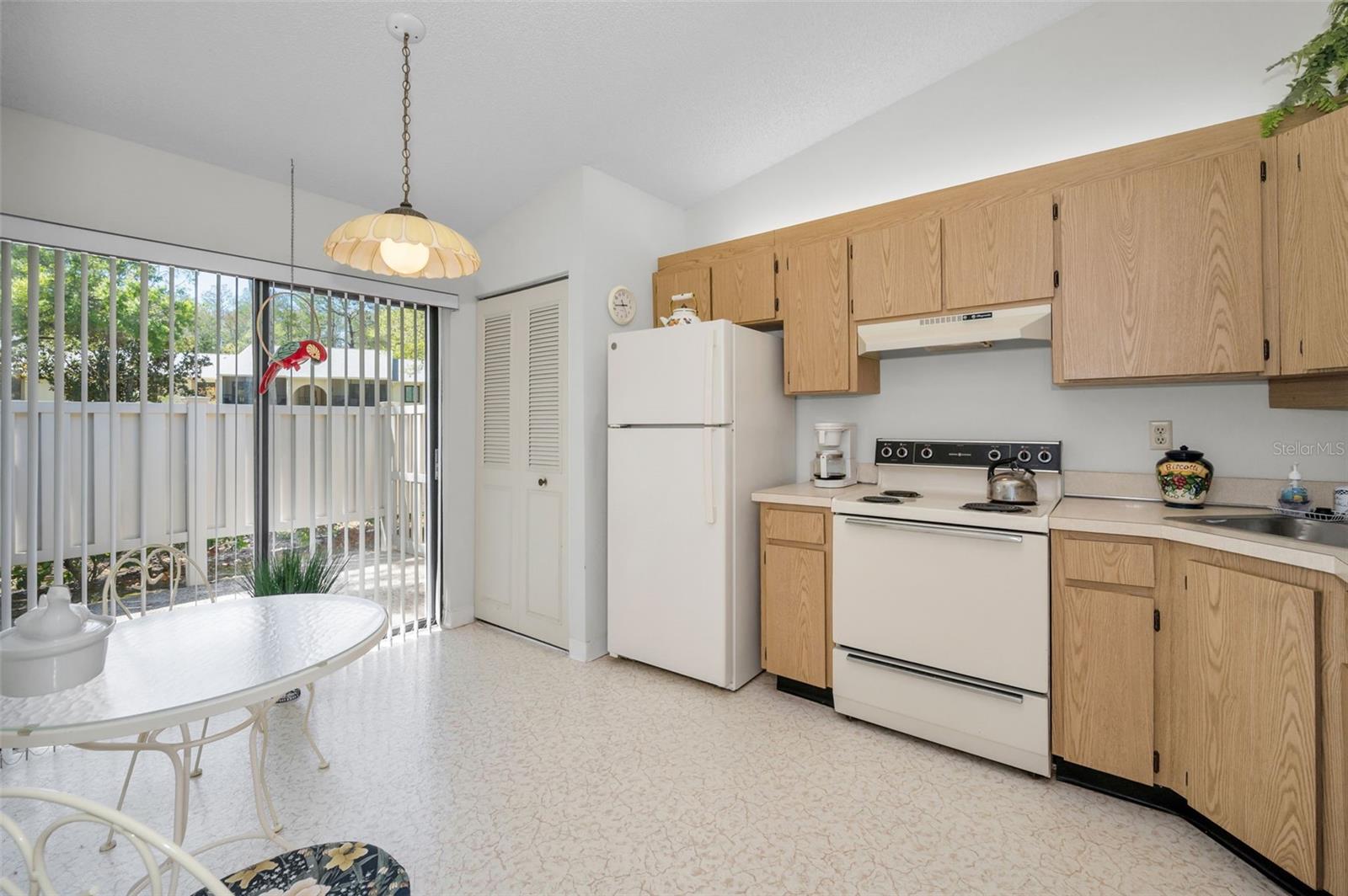 Kitchen With Laundry Closet, Eating Space, and Slider To The Front Patio Kitchen With Laundry Closet, Eating Space, and Slider To The Front Patio