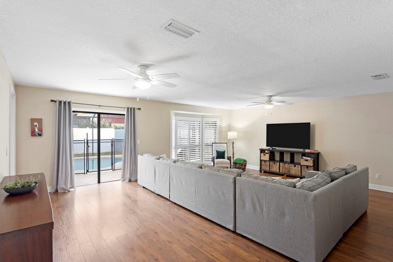These Floors are Beautiful! Enjoy Pool and Patio Views from Your Media Room