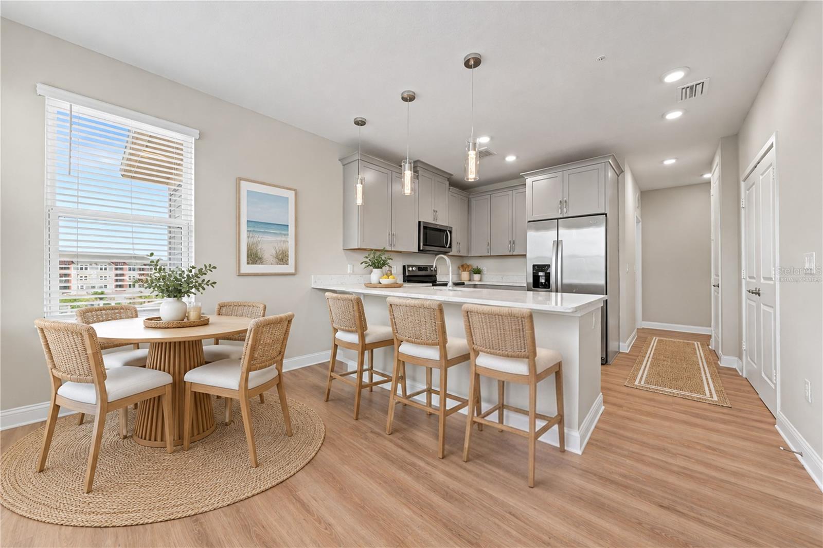 Virtually staged kitchen with table and counter stools
